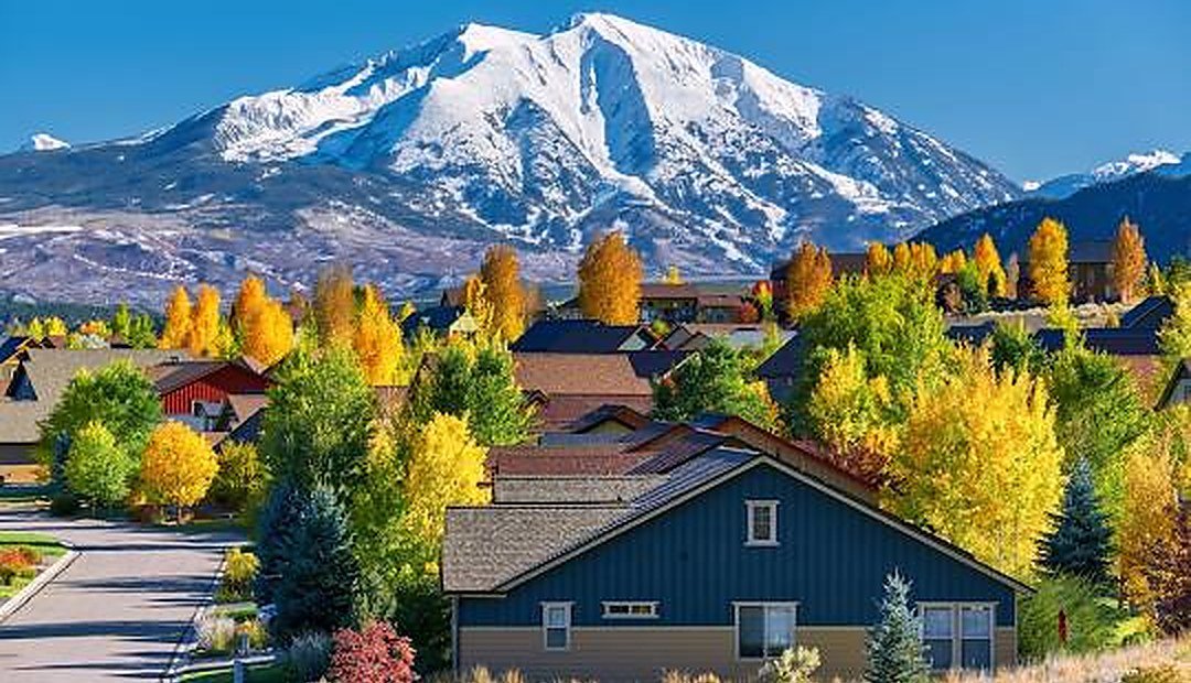 Colorado mountain community with autumn trees, representing Colorado down payment assistance programs