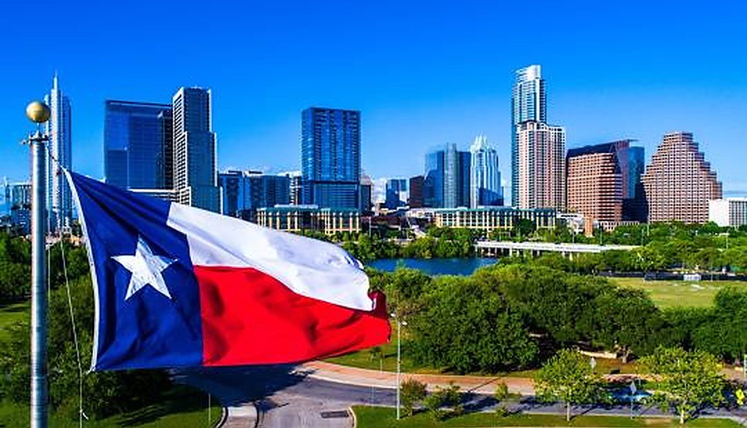 Austin skyline with a large Texas flag, representing Texas down payment assistance programs